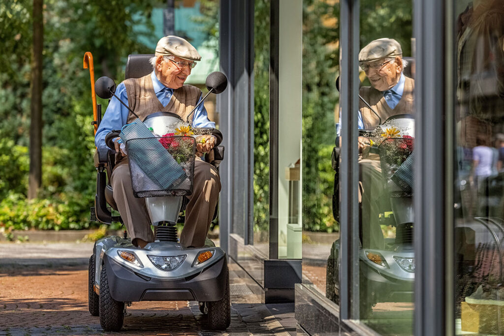 elderly man shopping on mobility scooter