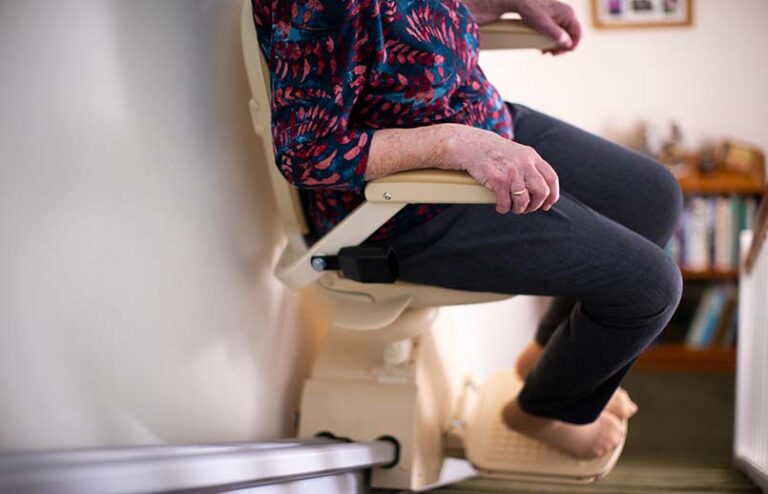 woman on stair lift for mobility