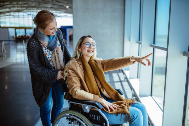 women with her mom in a wheelchair at the airport